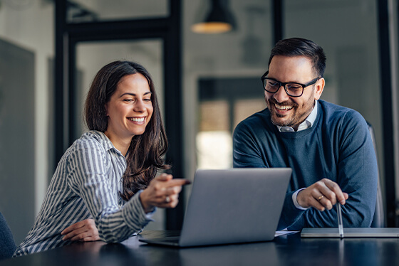 Business man and woman designing a website on a computer using GrowthLine