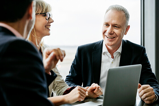 Business woman demonstrating MarketingCentral functionality with laptop